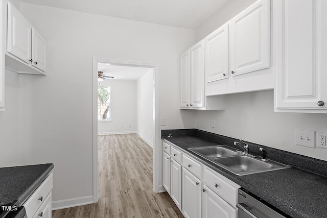 kitchen featuring dishwasher, sink, white cabinets, ceiling fan, and light hardwood / wood-style flooring