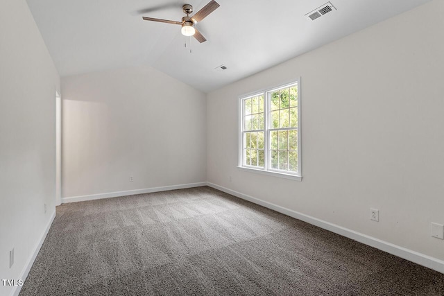 carpeted spare room featuring lofted ceiling and ceiling fan