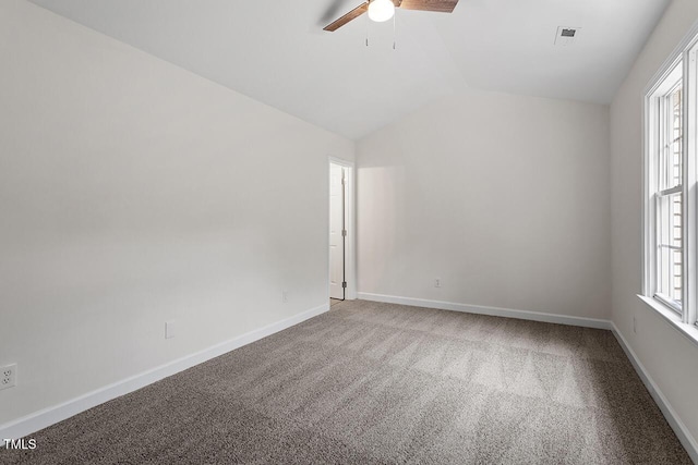 spare room featuring ceiling fan, lofted ceiling, and carpet flooring