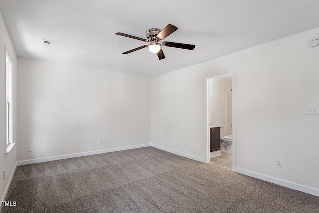 carpeted spare room featuring ceiling fan