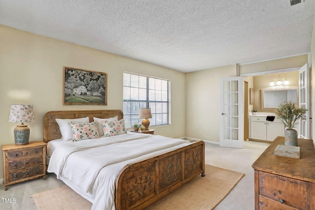 bedroom featuring light colored carpet, french doors, and a textured ceiling