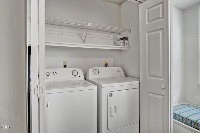 clothes washing area with washing machine and clothes dryer