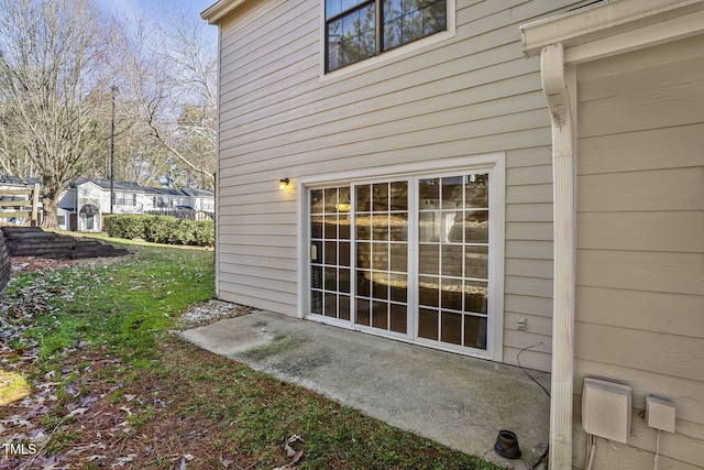 view of side of home with a lawn