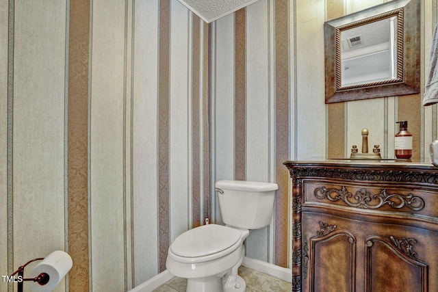 bathroom featuring tile patterned flooring, vanity, and toilet