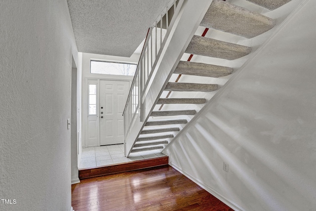 entrance foyer with wood-type flooring and a textured ceiling