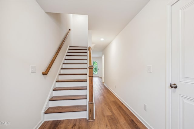 staircase with wood-type flooring