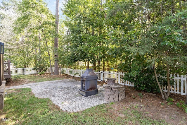 view of yard with an outdoor fire pit and a patio area