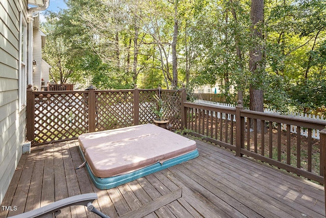 wooden deck featuring a covered hot tub