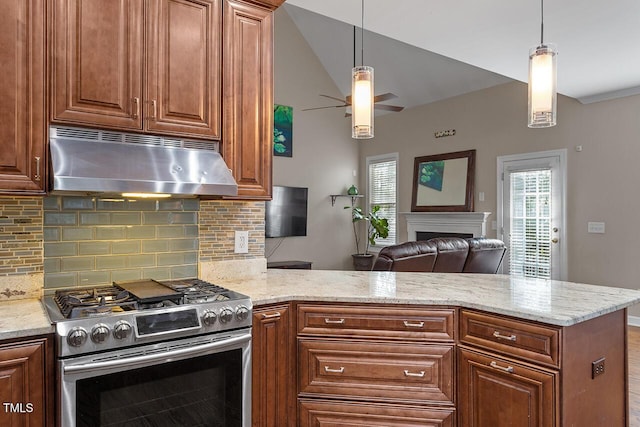 kitchen featuring pendant lighting, stainless steel gas range oven, light stone countertops, and kitchen peninsula