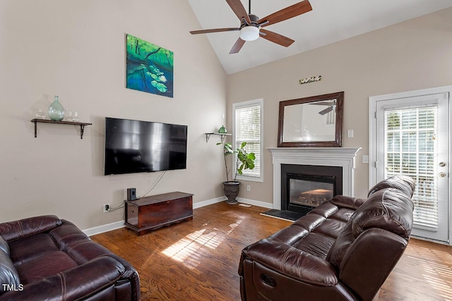 living room with wood-type flooring, high vaulted ceiling, and ceiling fan