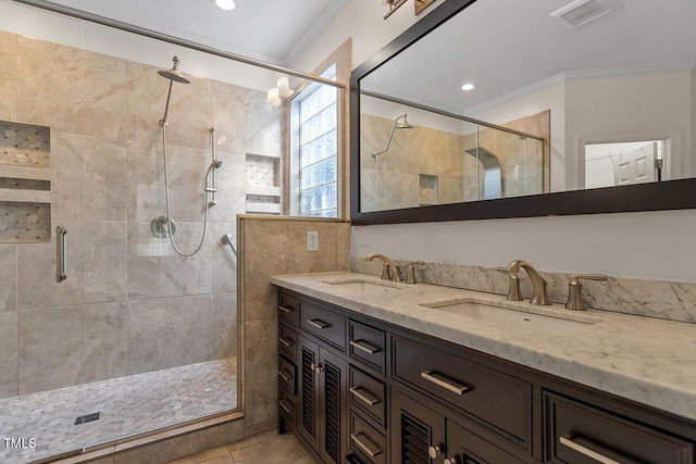 bathroom with vanity, an enclosed shower, crown molding, and tile patterned flooring