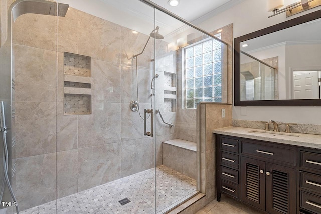 bathroom with a shower with door, crown molding, tile patterned flooring, and vanity