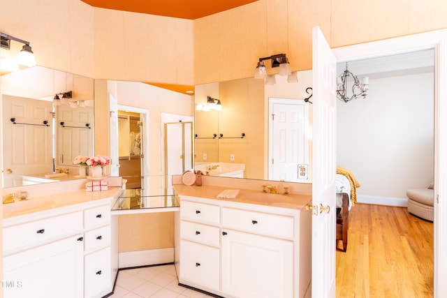 bathroom with vanity, a notable chandelier, and wood-type flooring