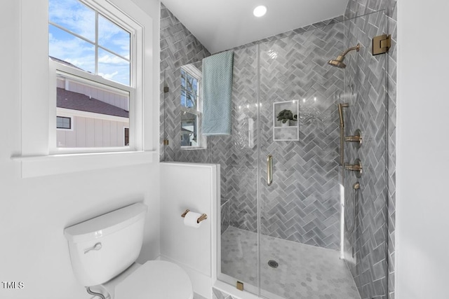 bathroom featuring walk in shower and toilet