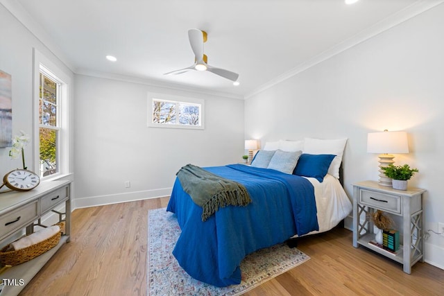 bedroom with crown molding, ceiling fan, and light wood-type flooring