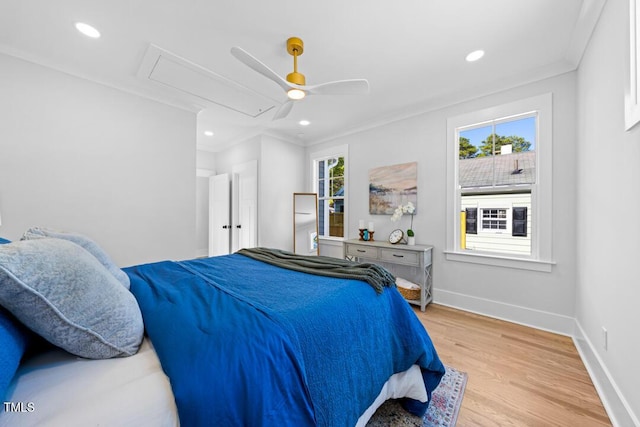 bedroom featuring crown molding, ceiling fan, and light hardwood / wood-style flooring