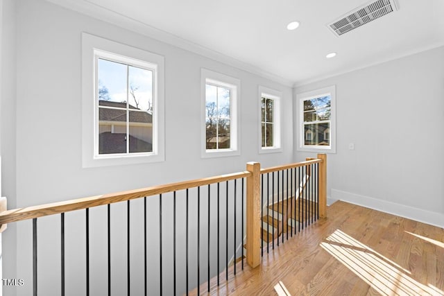 corridor with crown molding and light hardwood / wood-style floors