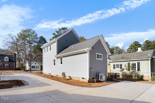 view of side of home with ac unit