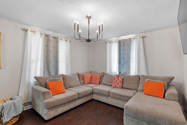 living room with a notable chandelier and dark wood-type flooring