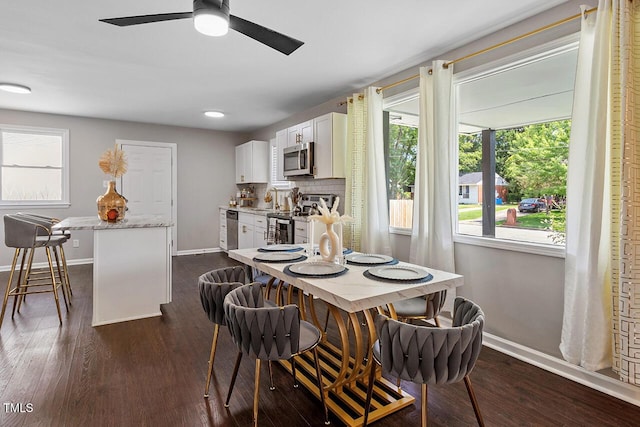 dining room with ceiling fan, dark hardwood / wood-style flooring, and sink