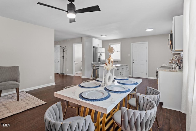 dining area with dark hardwood / wood-style flooring, sink, and ceiling fan