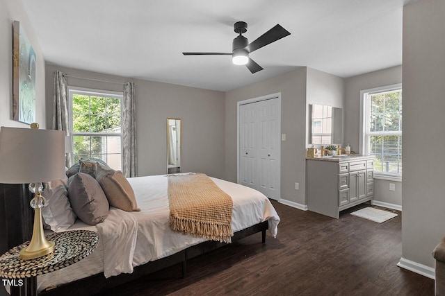 bedroom featuring dark wood-type flooring, a closet, and ceiling fan