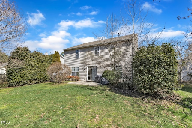 rear view of property with a patio and a yard