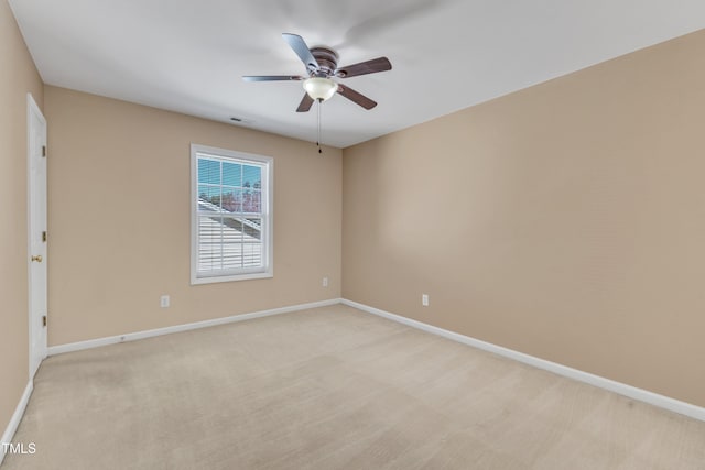 unfurnished room featuring baseboards, light carpet, visible vents, and ceiling fan