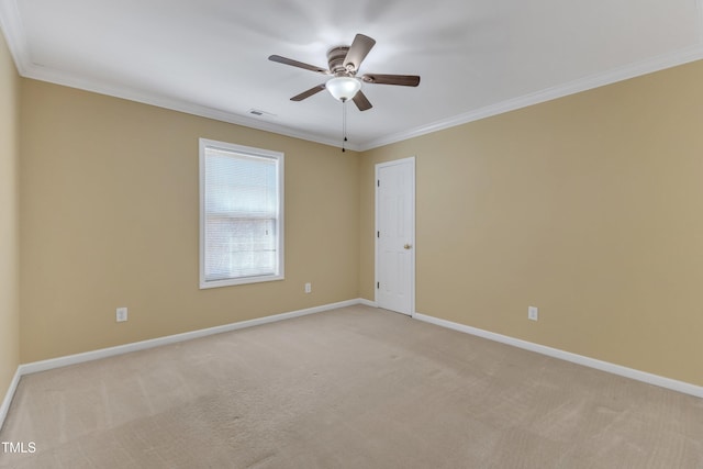 spare room featuring baseboards, light carpet, and crown molding