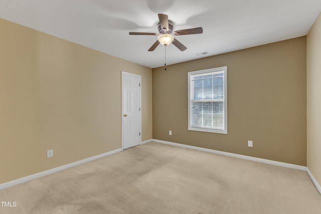 empty room featuring light carpet, baseboards, visible vents, and ceiling fan