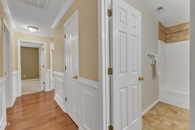 hallway featuring visible vents and crown molding