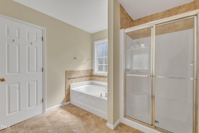 full bath featuring a bath, a stall shower, and baseboards