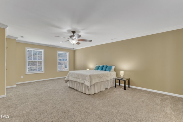 carpeted bedroom featuring a ceiling fan, baseboards, and ornamental molding