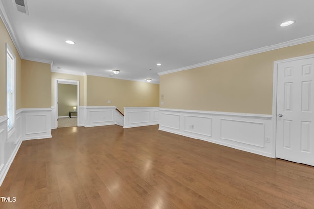 spare room featuring visible vents, recessed lighting, ornamental molding, and wood finished floors