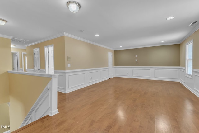 empty room featuring recessed lighting, visible vents, light wood-style flooring, and crown molding