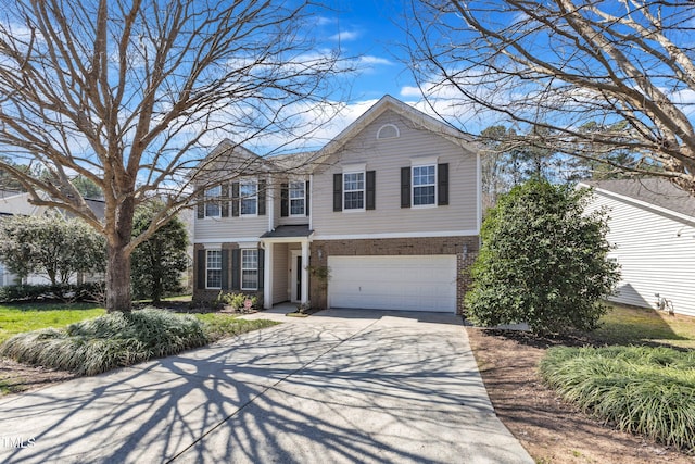 traditional-style home featuring brick siding, driveway, and a garage