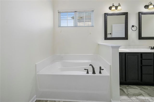 bathroom with vanity and a washtub