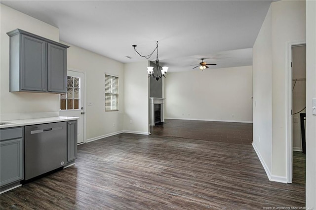 interior space with dark hardwood / wood-style flooring, ceiling fan with notable chandelier, and gray cabinets