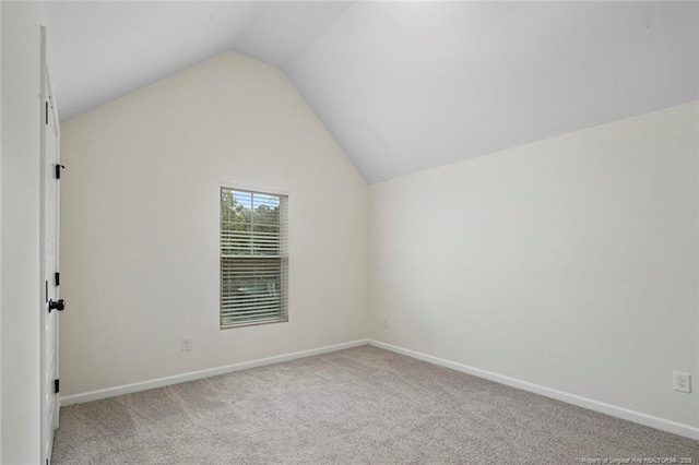 bonus room with light carpet and vaulted ceiling