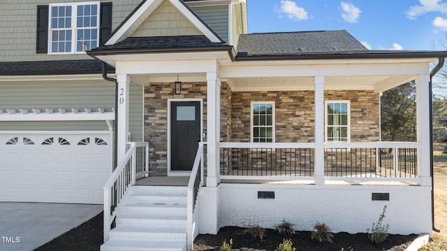 view of front of property featuring a garage and a porch