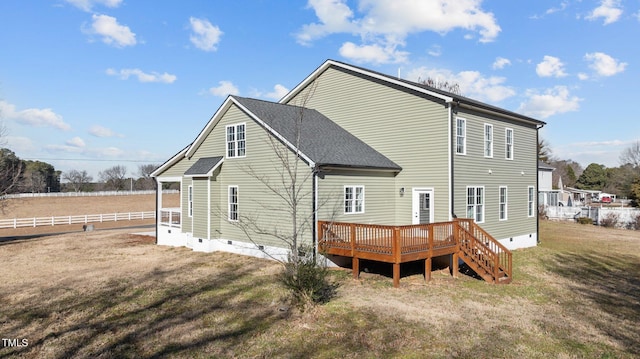 rear view of property with a yard and a deck