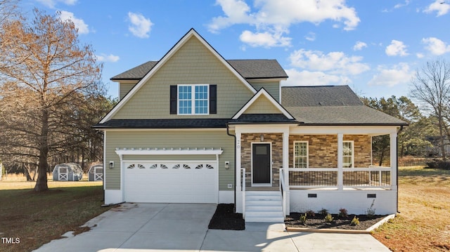 view of front of property featuring a porch, a garage, and a front lawn