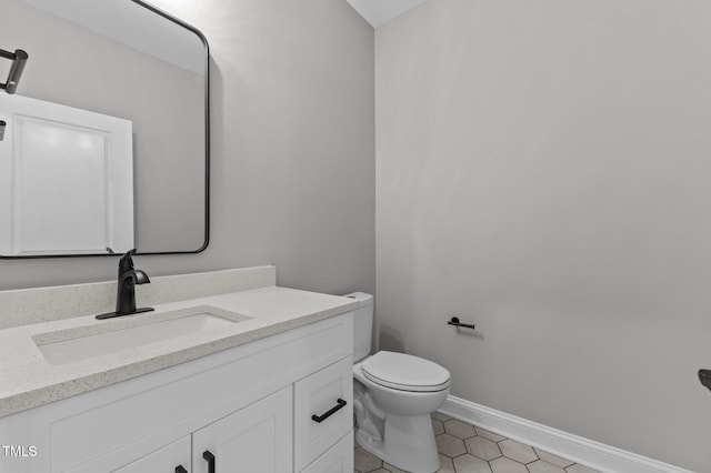 bathroom featuring tile patterned floors, vanity, and toilet