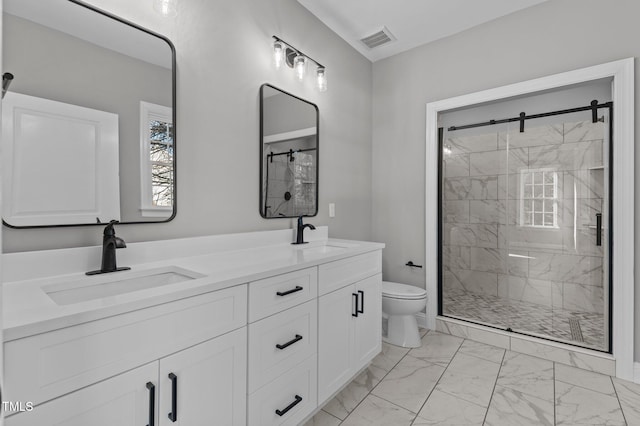 bathroom with vanity, toilet, and a shower with door