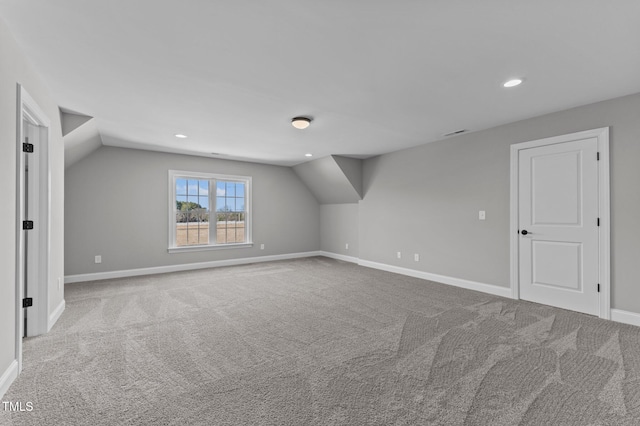 bonus room featuring carpet floors and vaulted ceiling