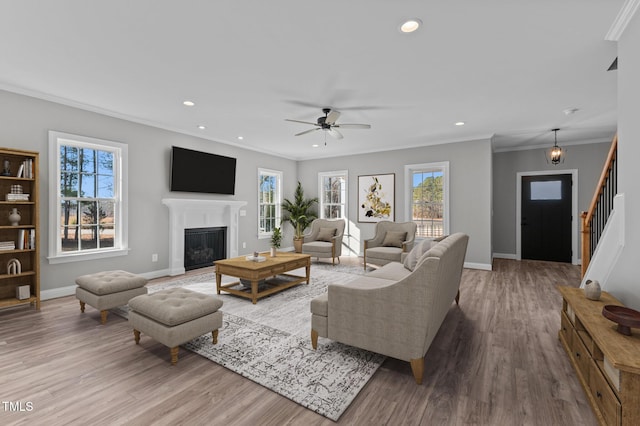 20 Wes Sandling Rd, Franklinton, NC 27525 - living room with crown molding, wood finished floors, stairs, a glass covered fireplace, and baseboards
