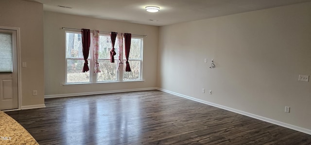 empty room featuring dark hardwood / wood-style flooring