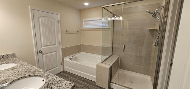 bathroom with vanity and separate shower and tub