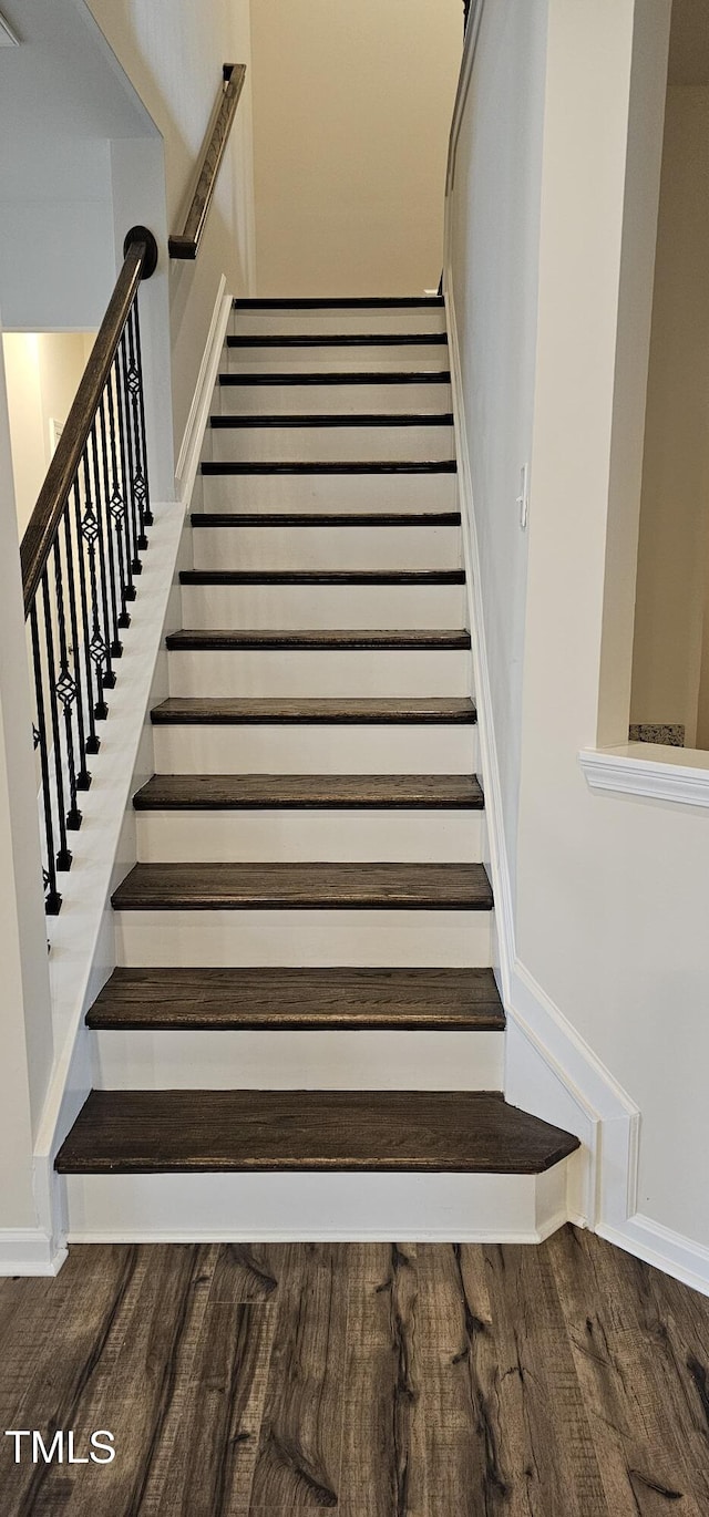 staircase with hardwood / wood-style flooring