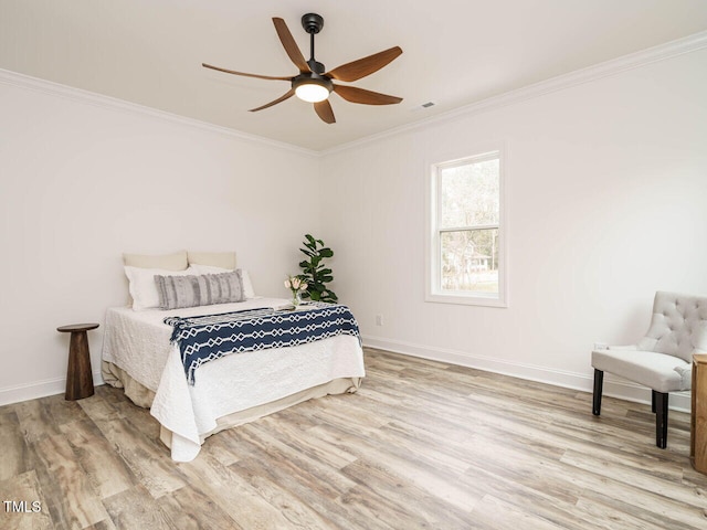 bedroom featuring ornamental molding, ceiling fan, and light hardwood / wood-style floors